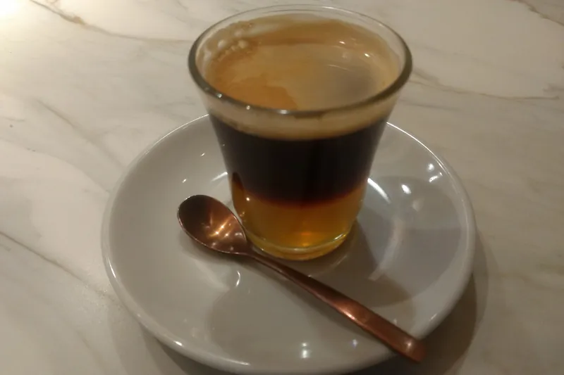 Cremaet servido en vaso de cristal sobre una mesa de mármol